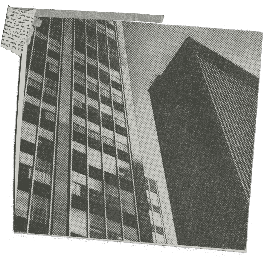 A newspaper clipping containing a photo of two skyscrapers taken from the ground.